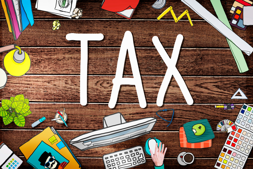“Tax concept illustration with office desk items and financial theme background”
