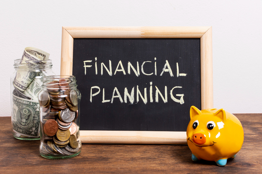 Financial planning concept with savings jars, coins, dollar bills, and a yellow piggy bank on a wooden table
